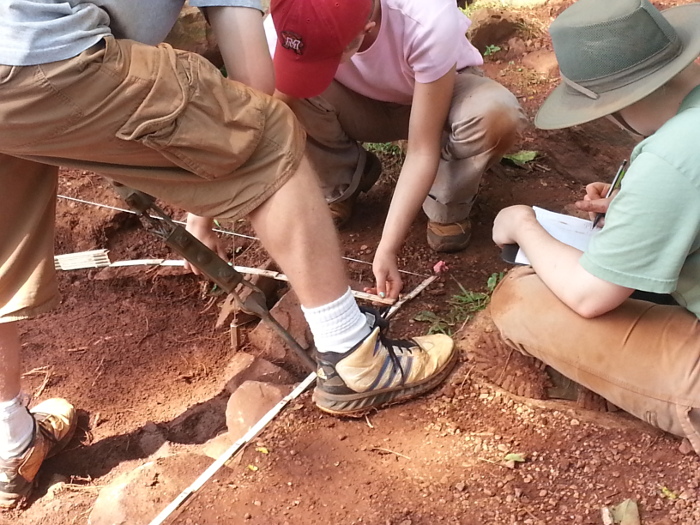 Researchers measure excavation site